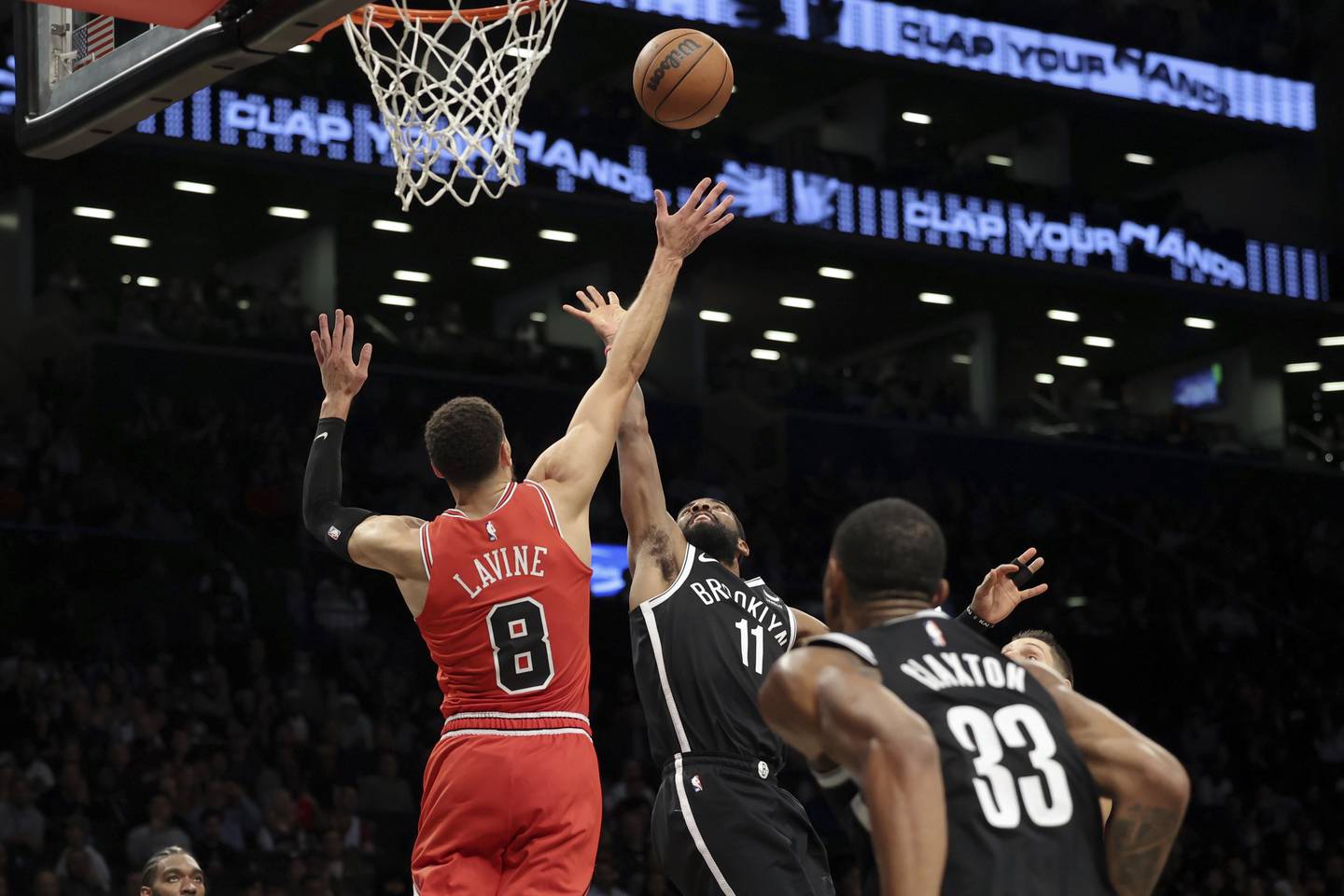 Bulls guard Zach LaVine (8) defends Nets guard Kyrie Irving (11) as Nets forward Nic Claxton (33) watches during the second half Tuesday, Nov. 1, 2022, in New York.