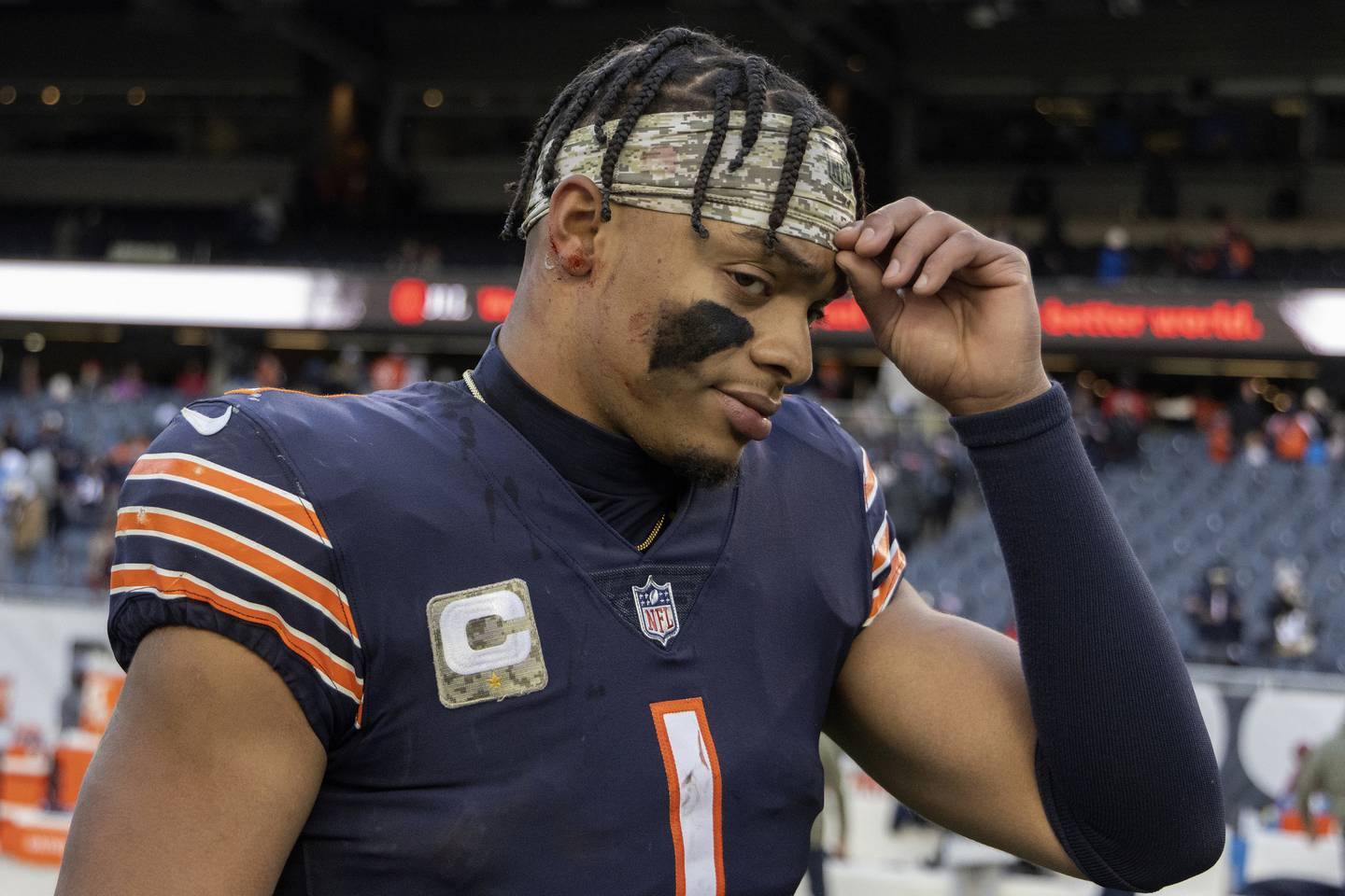 Bears quarterback Justin Fields leaves the field with a bloody ear after his team’s 31-30 loss to the Lions on Nov. 13, 2022.