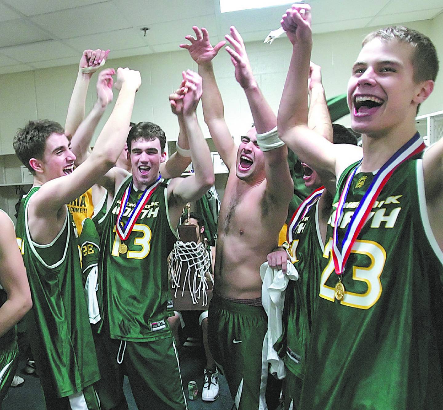 Jon Scheyer (23) and his Glenbrook North teammates celebrate in the locker room after beating Carbondale to win the IHSA Class AA state championship on March 19, 2005, in Peoria.
