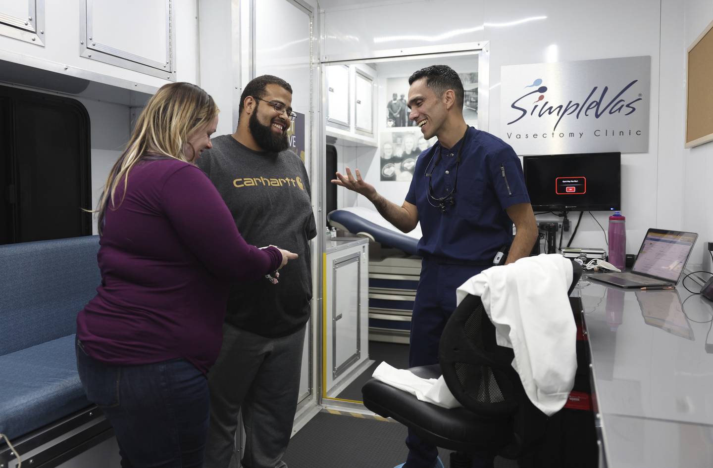 Dr. Esgar Guarín talks with a patient named Nicholas, 31, and Brittany, 30, after performing a vasectomy on Nicholas in his mobile medical clinic on Oct. 29, 2022.