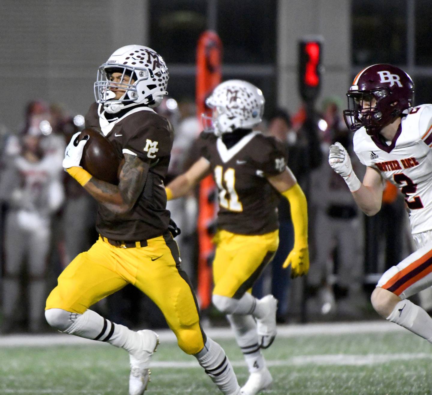 Mount Carmel's Damarion Arrington, left, heads to the end zone ahead of Brother Rice's Jack Morrison (2) during a Class 7A state quarterfinal game in Chicago on Saturday, Nov. 12, 2022.