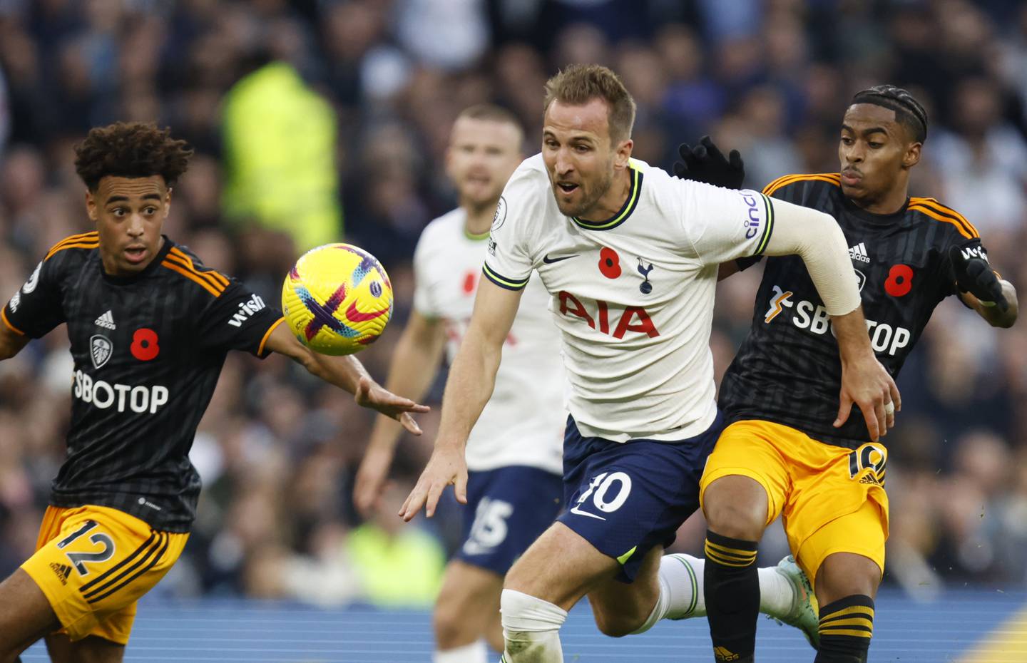 Tottenham's Harry Kane, center, duels for the ball with Leeds United's Crysencio Summerville during an English Premier League match Nov. 12, 2022, in London.