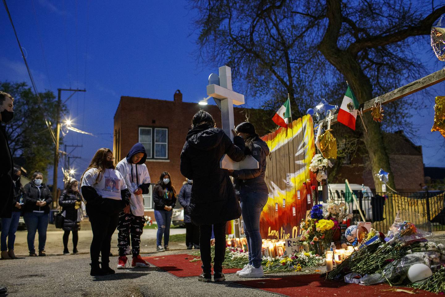 Mourners gather at the scene, on April 21, 2021, for a blessing ceremony for 13-year-old Adam Toledo who was fatally shot by police in March of 2021 during a foot pursuit.