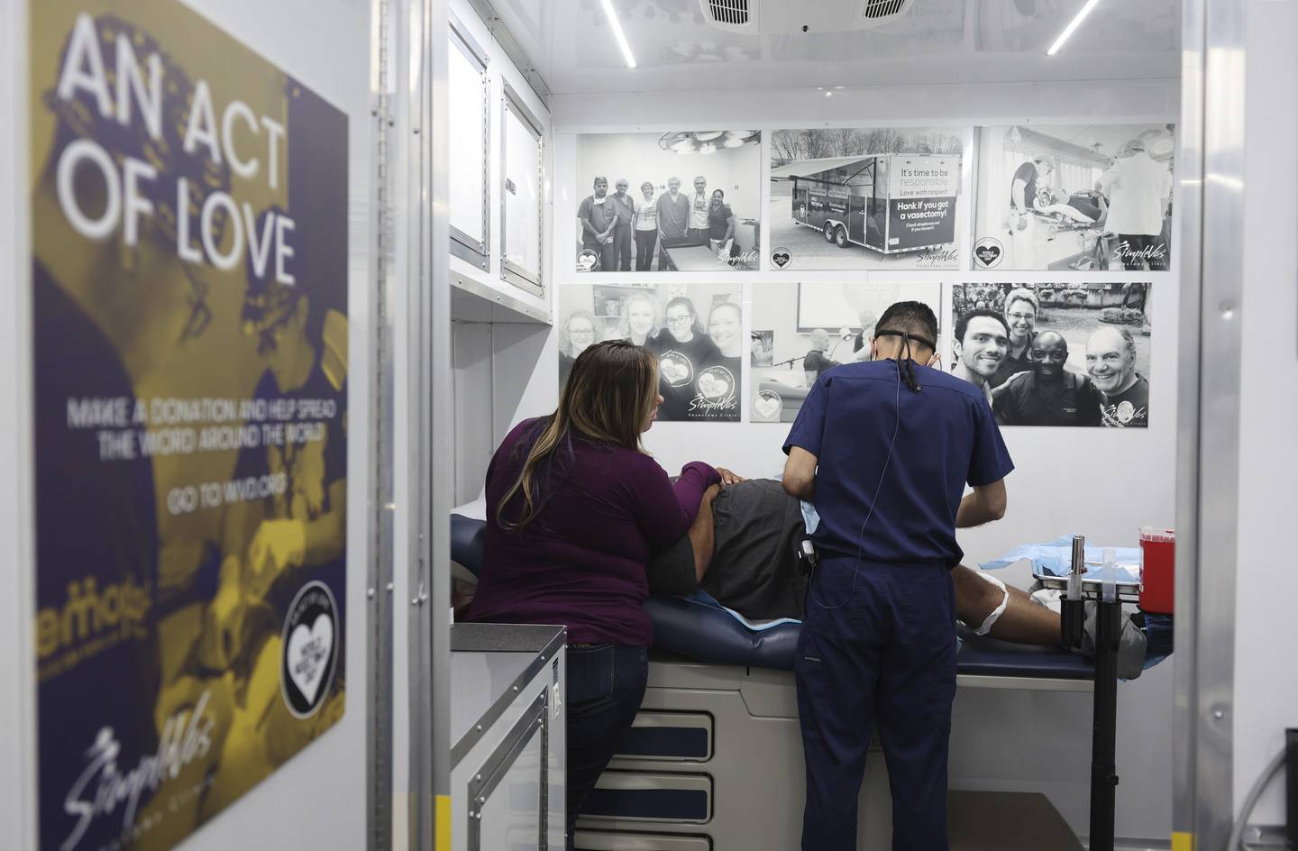 Brittany, 30, observes as Dr. Esgar Guarín performs a vasectomy on a patient named Nicholas, 31, in his mobile medical clinic on Oct. 29, 2022, in Waterloo, Iowa. Nicholas and Brittany are not partners but are co-parenting their three children from when they were together in previous years.