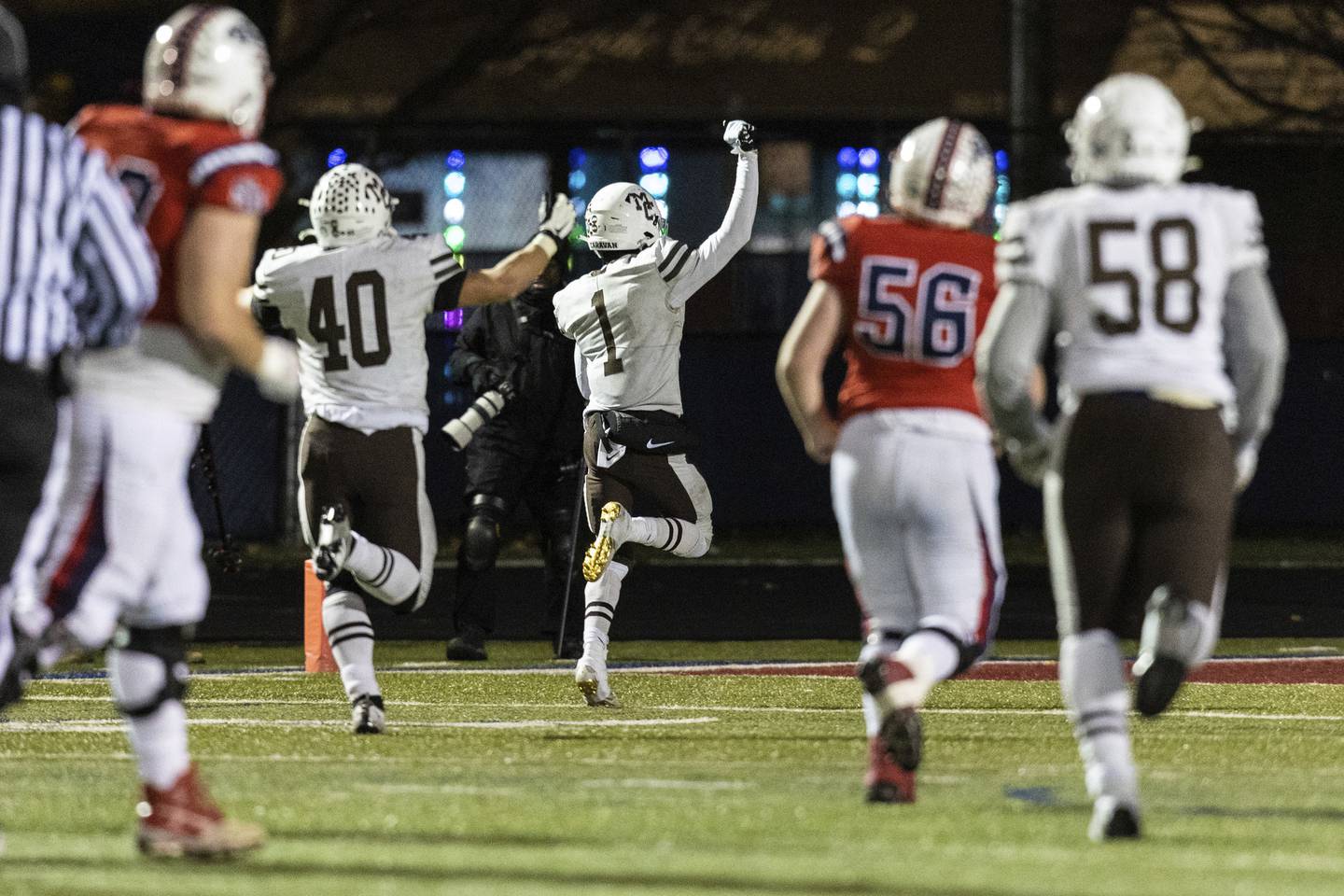 Mount Carmel's Nick Naujokas (40) and Damarion Arrington (1) celebrate as Arrington runs an interception back for a touchdown against St. Rita during a Class 7A state semifinal game in Chicago on Saturday, Nov. 19, 2022.