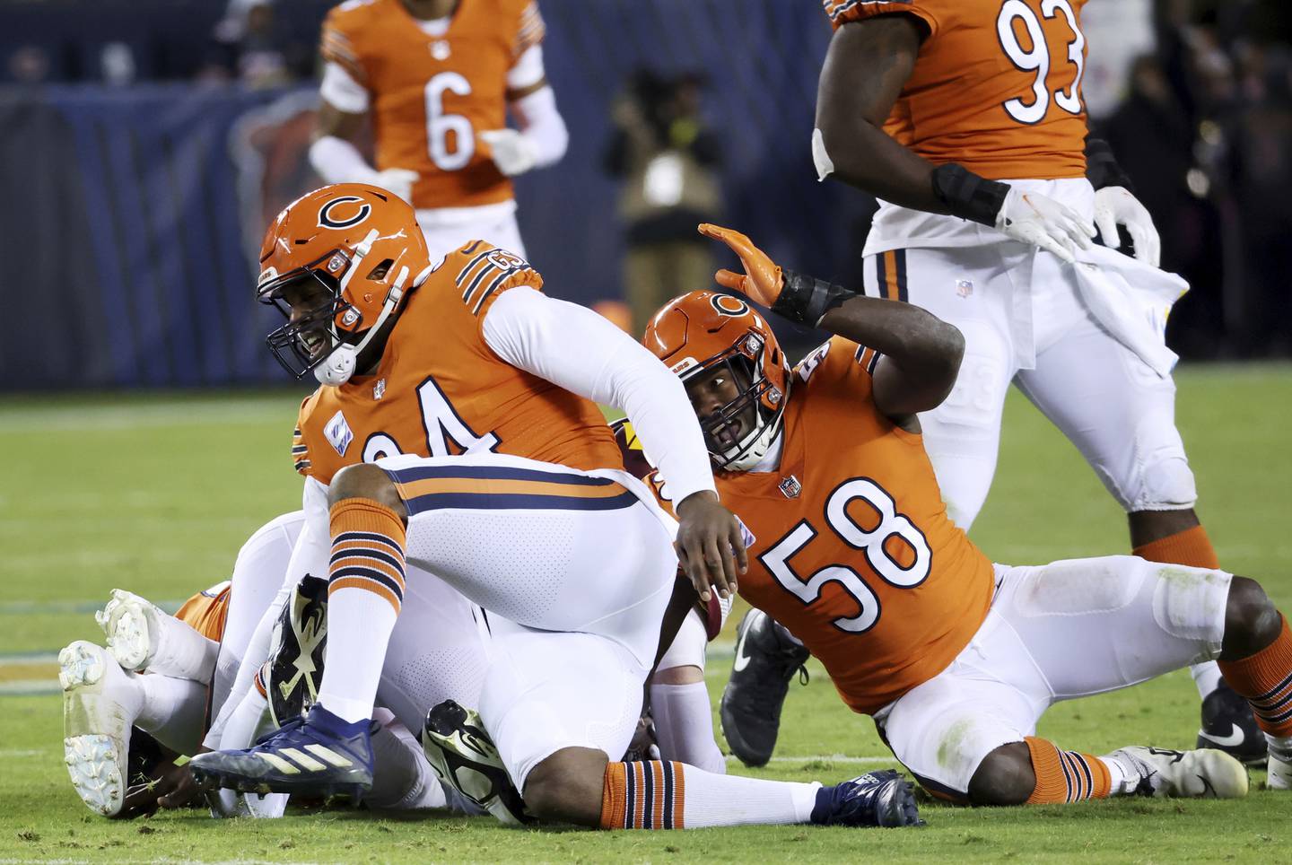 Bears defensive end Robert Quinn, left, and linebacker Roquan Smith tackle Commanders quarterback Carson Wentz in the third quarter on Oct. 13 at Soldier Field. 