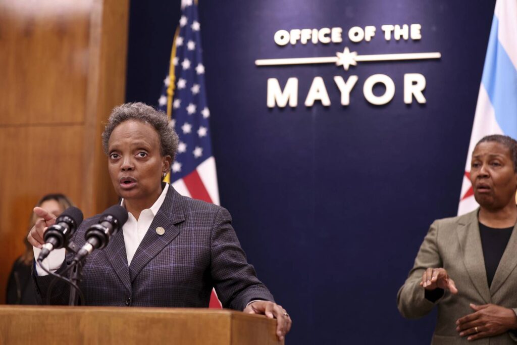 Mayor Lori Lightfoot chastises security detail for parking in a bike lane while she picked up doughnuts