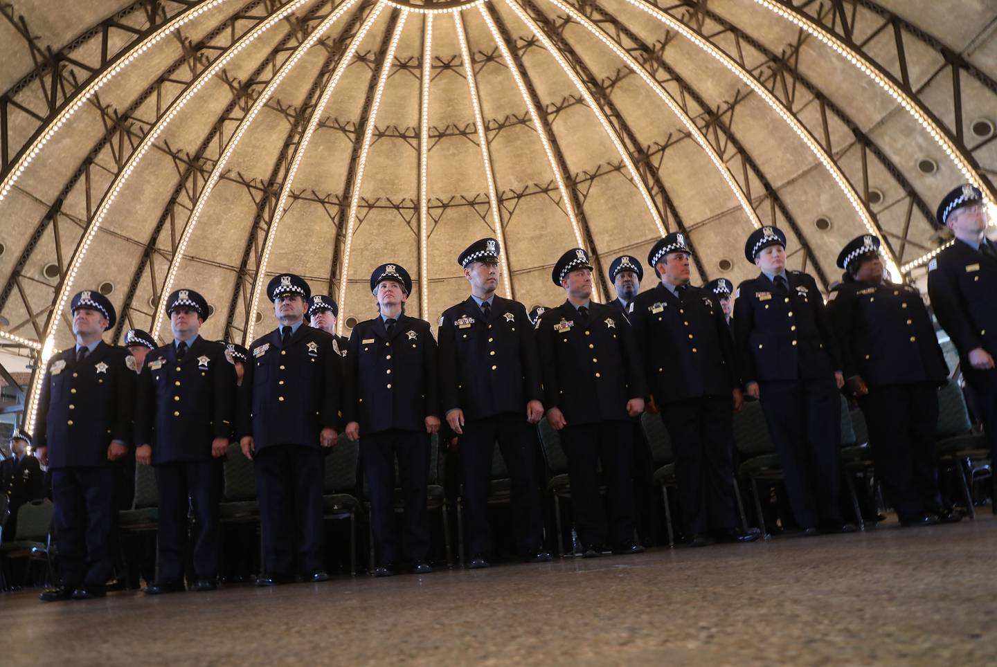 Police officers stand during the Chicago Police Department's graduation and promotion ceremony at Navy Pier, March 29, 2022.  