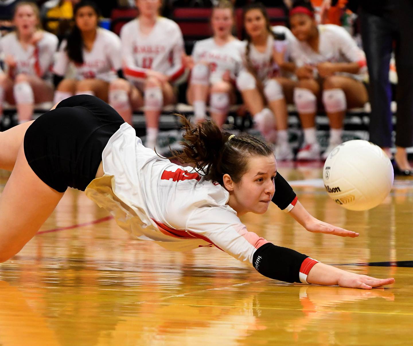 Mother McAuley's Sam Falk (4) makes a pancake save against Benet during the Class 4A state championship match at Illinois State's Redbird Arena on Saturday, Nov. 12, 2022.