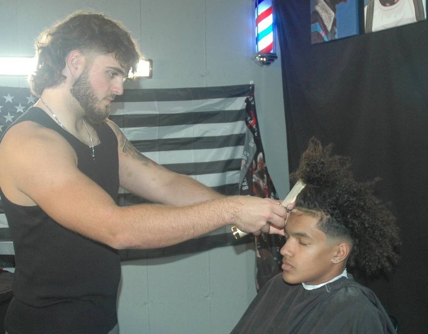 Yorkville's Andrew Laurich, who has taken his interest in cutting hair to the next level, works on teammate Isaiah Brown on Tuesday, Nov. 8, 2022.