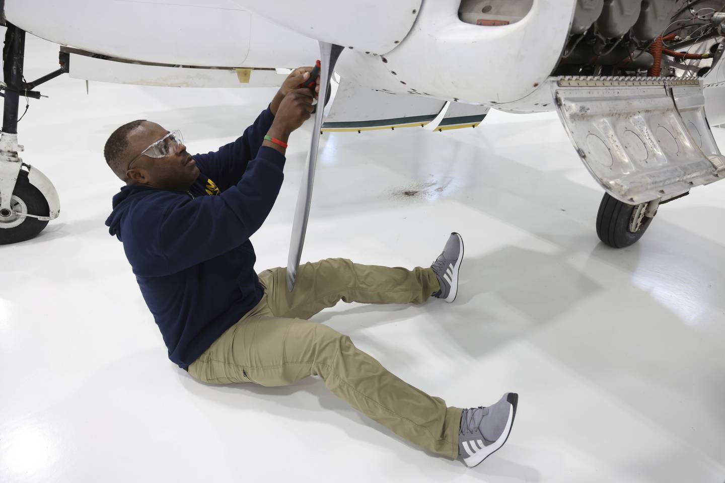 Eric Tsapi, screws on a piece of an aircraft on Oct. 24, 2022, in Chicago.