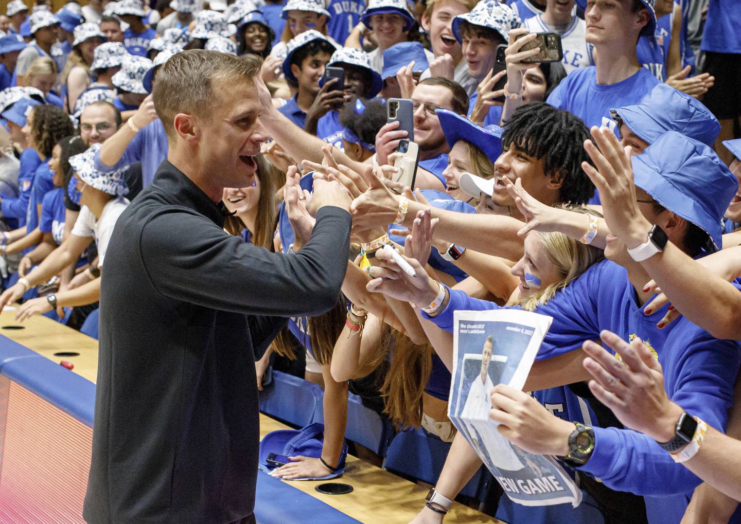 Jon Scheyer greets fans in the Duke student section after earning his first win as the Blue Devils head coach against Jacksonville on Nov. 7, 2022, in Durham, N.C.