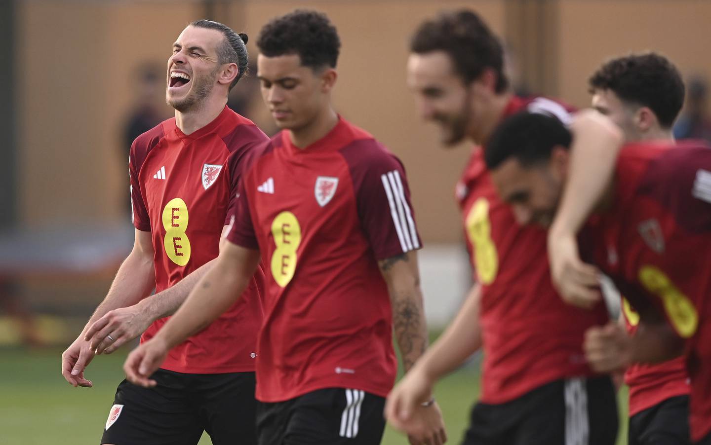 Wales captain Gareth Bale, left, shares a joke with team mates  during the Wales Training Session at Al Sad Sports Club on Nov. 17, 2022 in Doha, Qatar. 