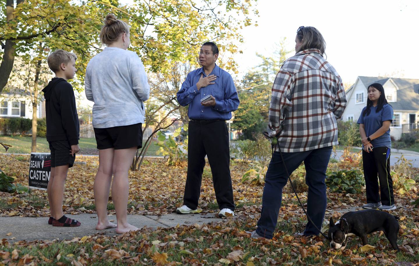 Paul Leong, Republican candidate for State House District 81, talks with prospective voter Jessica Hurt, second from left, while canvassing a neighborhood with his daughter, Hannah, 15, on Nov. 2, 2022, in Downers Grove. 