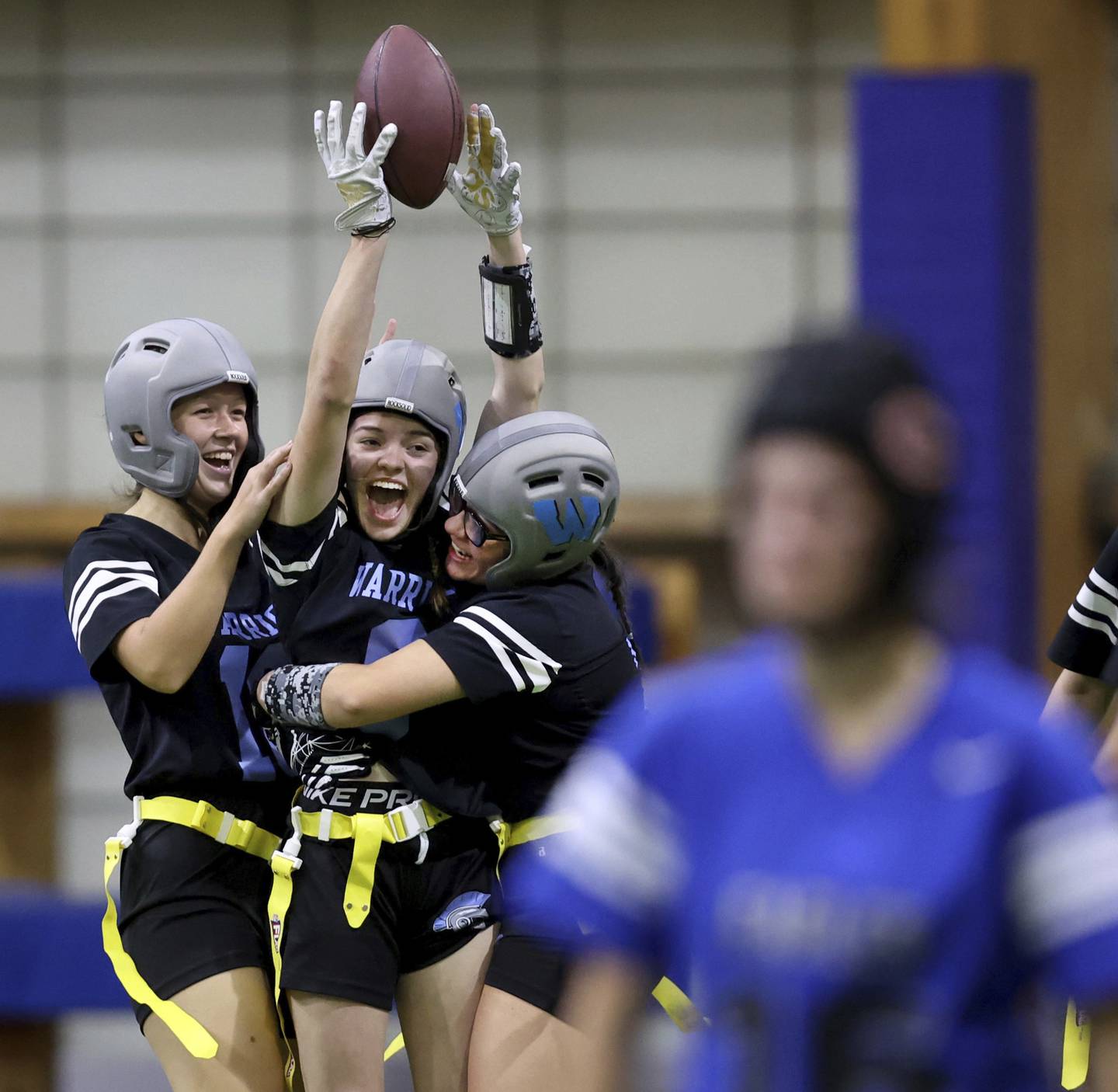 Willowbrook High School’s Rimon Kari is surrounded by teammates after Kari scored a touchdown on an interception during the championship game.