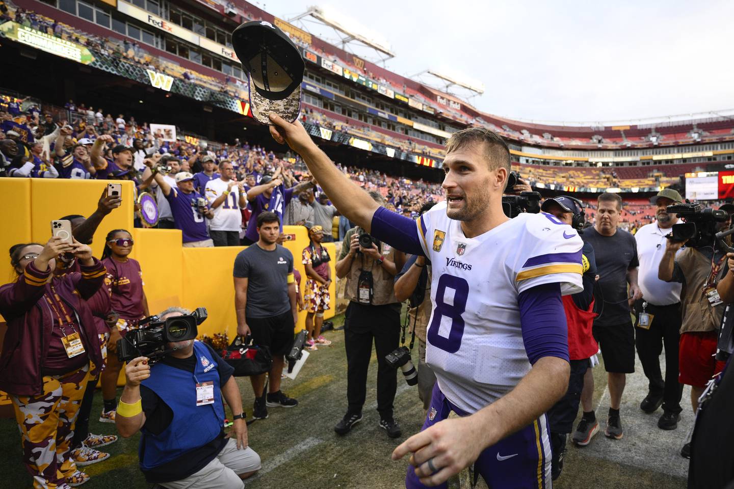 Vikings quarterback Kirk Cousins (8) waves his cap to fans as he walks off the field after a 20-17 victory against the Commanders on Sunday, Nov. 6, 2022, in Landover, Md.