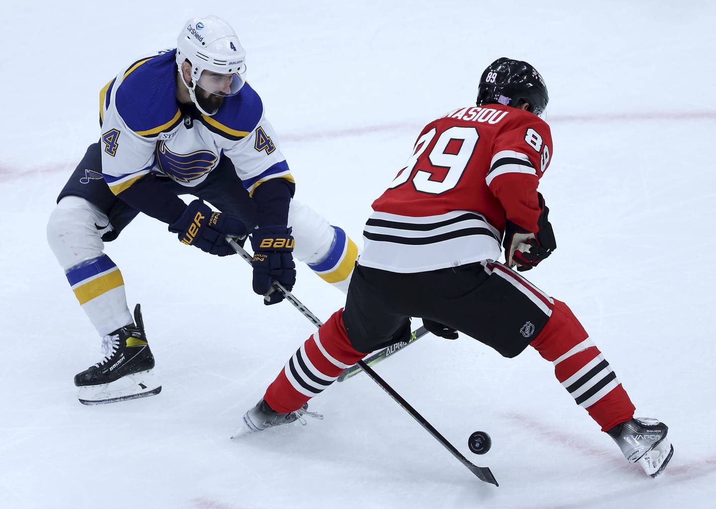 Blues defenseman Nick Leddy takes the puck away from Blackhawks center Andreas Athanasiou in the second period on Nov. 16, 2022.