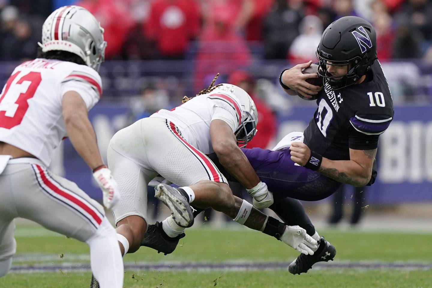 Northwestern quarterback Brendan Sullivan, right, is tackled by Ohio State safety Ronnie Hickman during the second half Saturday in Evanston. The Wildcats lost 21-7. 