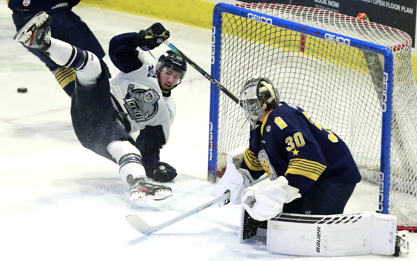 Norfolk goalie Dylan Wells makes a save on a shot from Jacksonville's Craig Martin's during an ECHL game on March 30, 2022, in Norfolk, Va.
