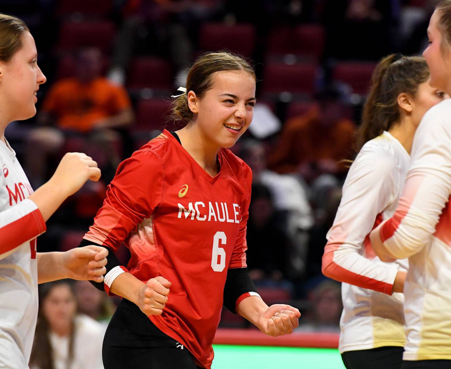 Mother McAuley's Gigi Navarrete (6) does a little dance as she comes out on the floor for the third game against Benet during the Class 4A state championship match on Saturday, Nov. 12, 2022.