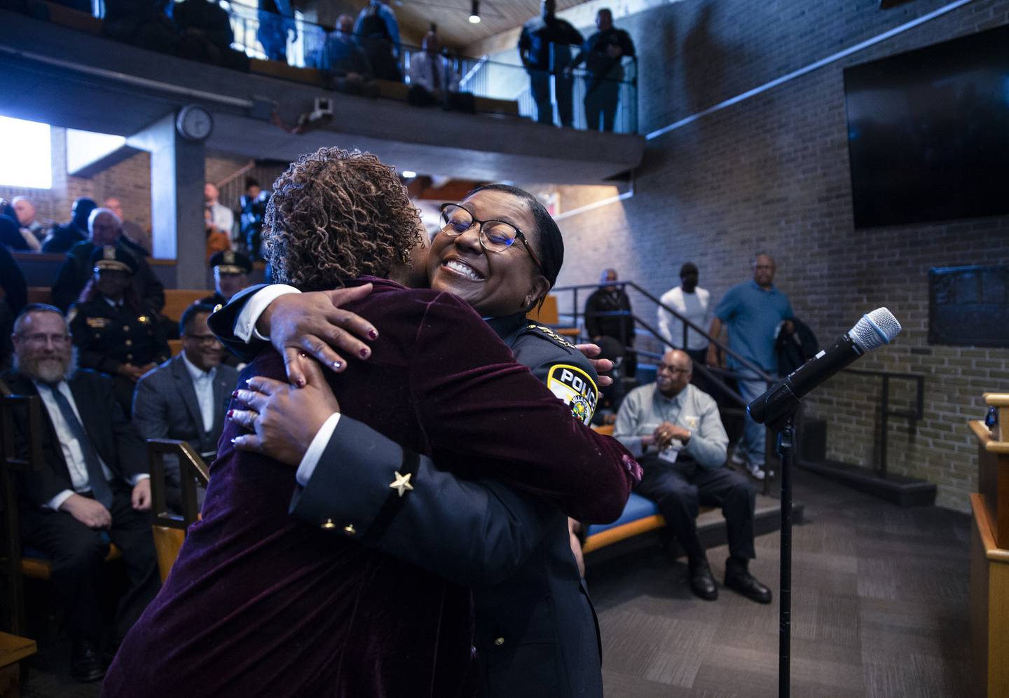 Shatonya Johnson, right, gets a hug from retired Oak Park police Commander Phyliss Howard after Johnson  was sworn in as the first woman police chief of the Oak Park Police Department. The swearing in took place at Village Hall in Oak Park.