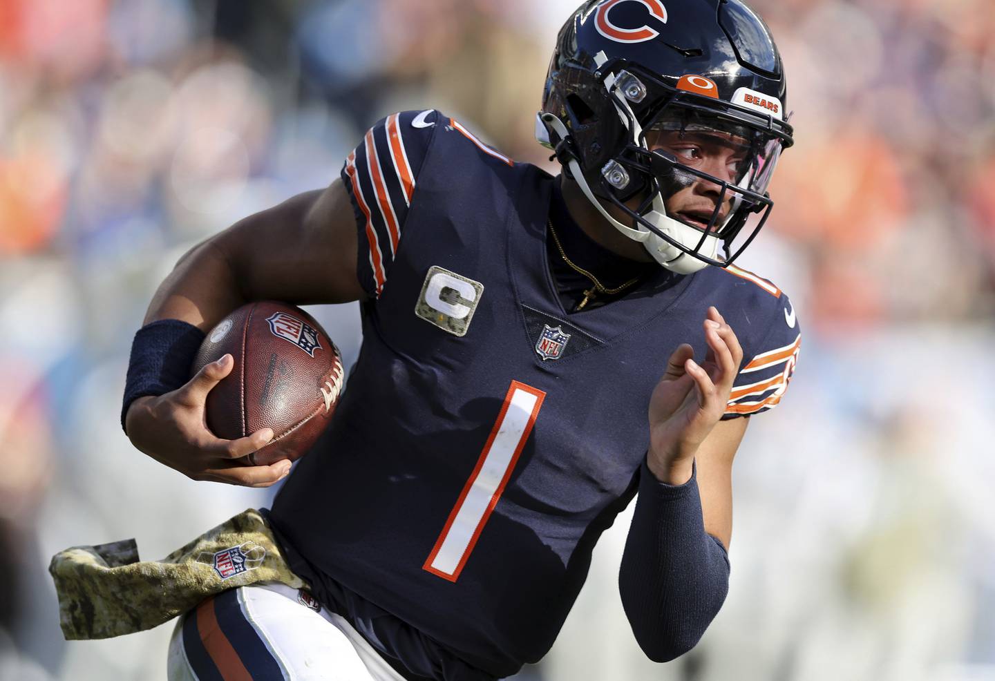 Bears quarterback Justin Fields heads downfield during a run in the fourth quarter against the Lions on Sunday at Soldier Field. 