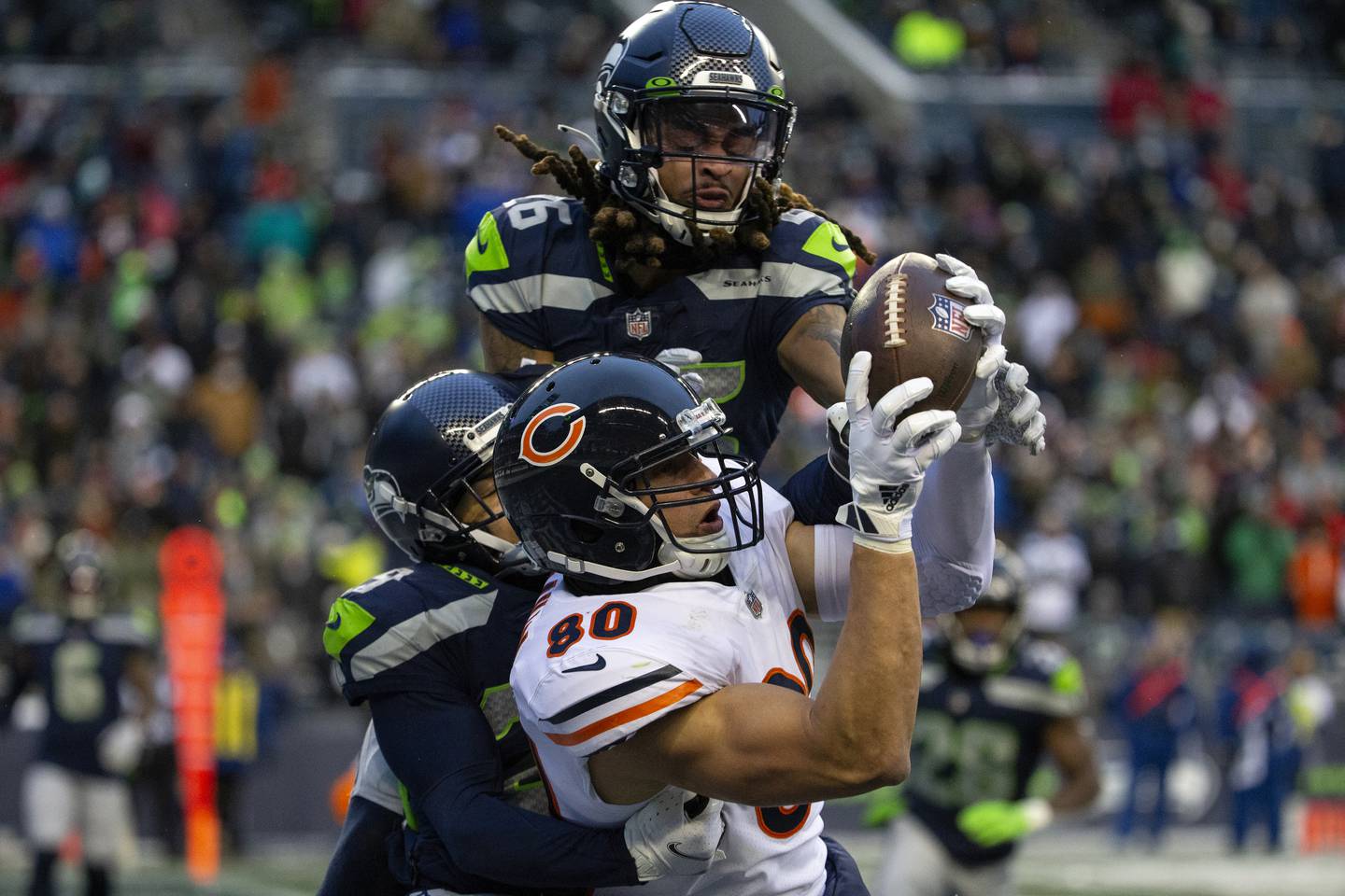 Bears tight end Jimmy Graham makes a touchdown catch as Seahawks defensive back Ryan Neal (26) and cornerback John Reid try to take him down during the fourth quarter on Dec. 26, 2021, at Lumen Field in Seattle. 