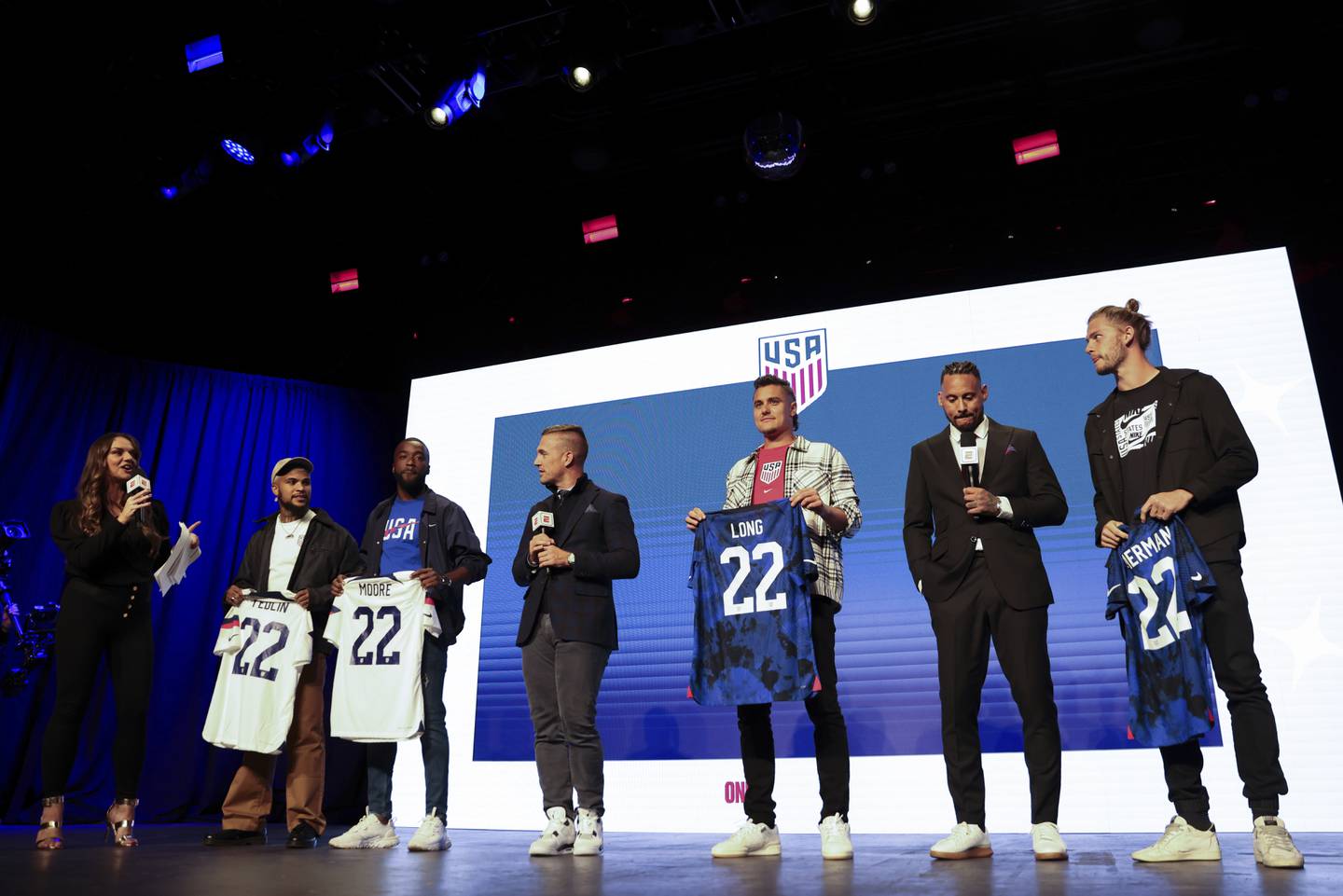 U.S. defenders DeAndre Yedlin, Shaq Moore, Aaron Long and Walker Zimmerman hold up jerseys after being named to the U.S. roster for the World Cup in Qatar on Nov. 9, 2022, in New York.
