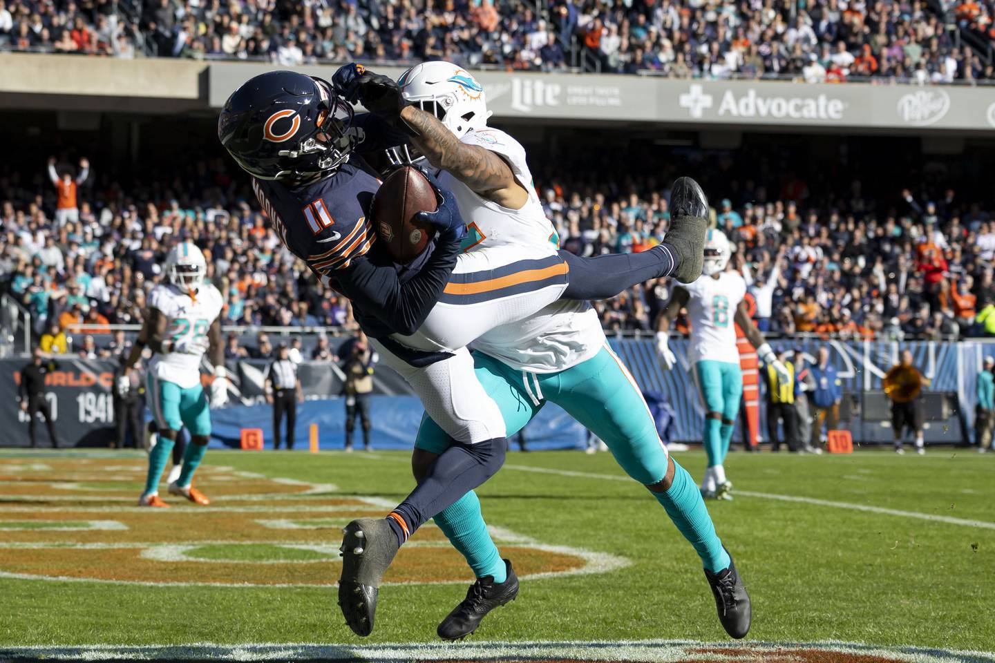 Bears wide receiver Darnell Mooney (11) comes down with a touchdown reception against Dolphins cornerback Xavien Howard (25) in the second quarter Sunday, Nov. 6, 2022, at Soldier Field.