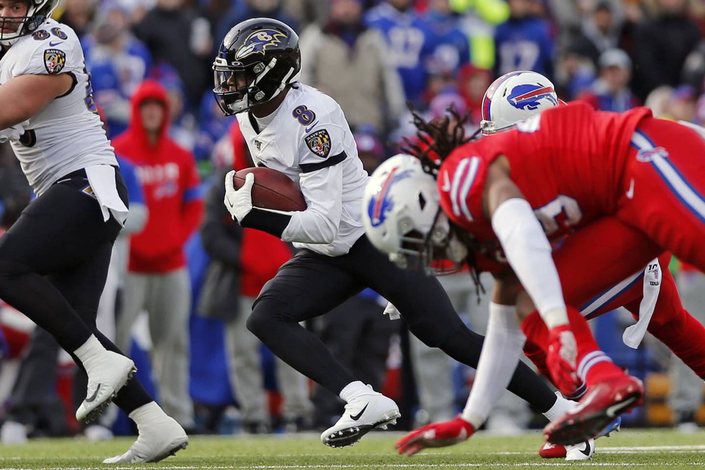 Ravens quarterback Lamar Jackson carries the ball during the first half against the Bills on Dec. 8, 2019, in Orchard Park, N.Y.