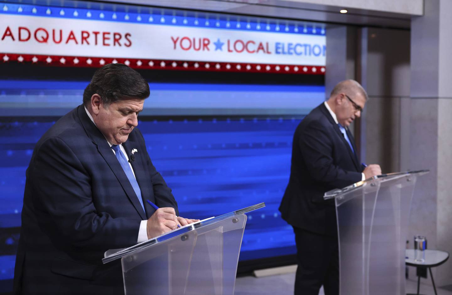 Democratic Gov. J.B. Pritzker and Republican state Sen. Darren Bailey prepare for their gubernatorial debate at WGN-TV studios on Oct. 18, 2022.