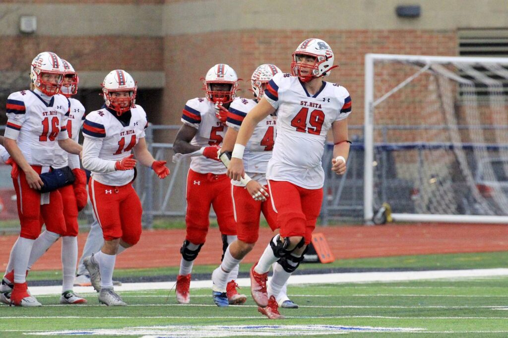 Under pressure: Illinois-bound defensive end Pat Farrell, who grew up on the same street as his head coach, likes to ‘make that bull rush’ for St. Rita.