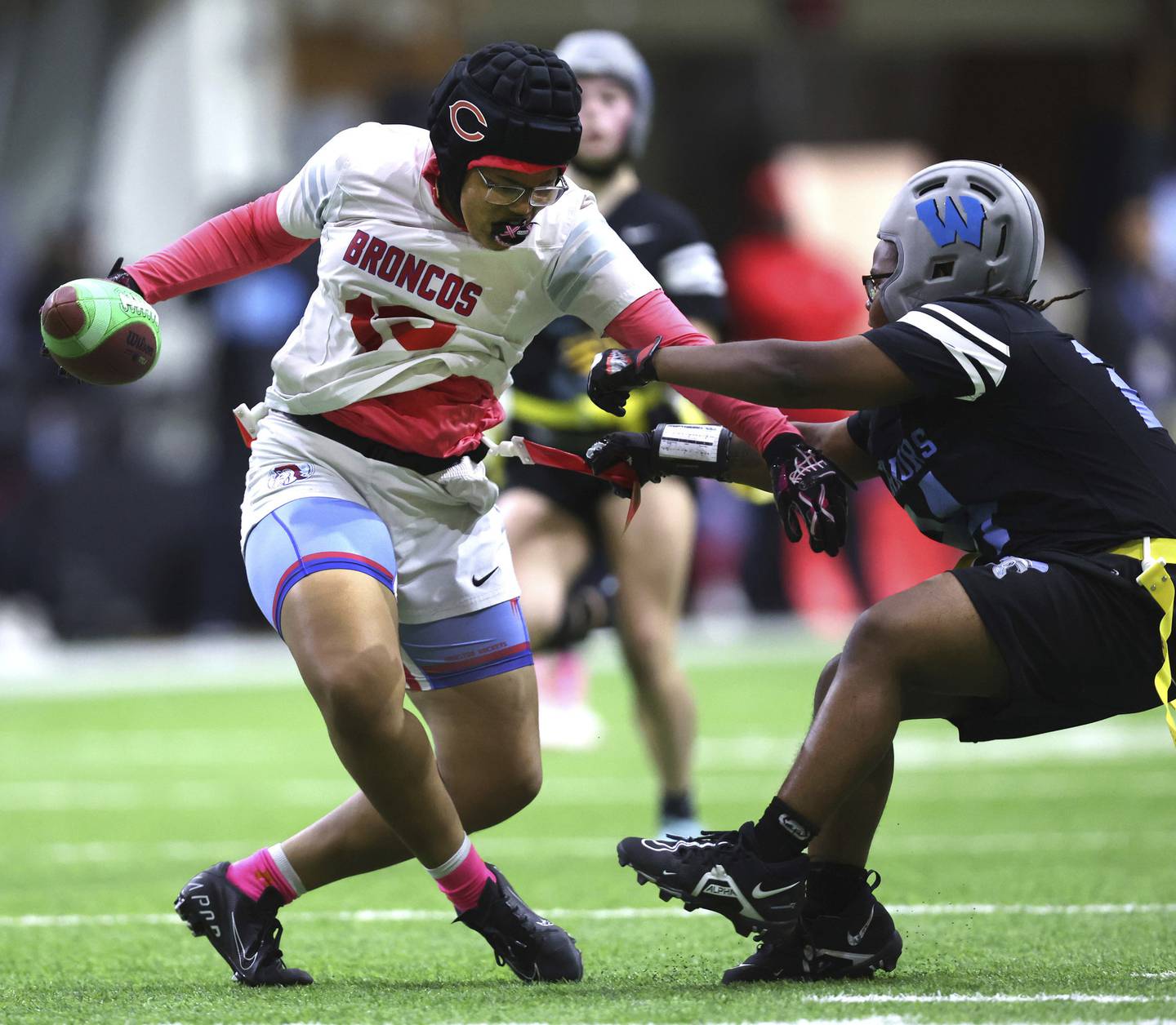 Kenwood Academy wide receiver Kennedy Scott is stopped by a Willowbrook High School defender.