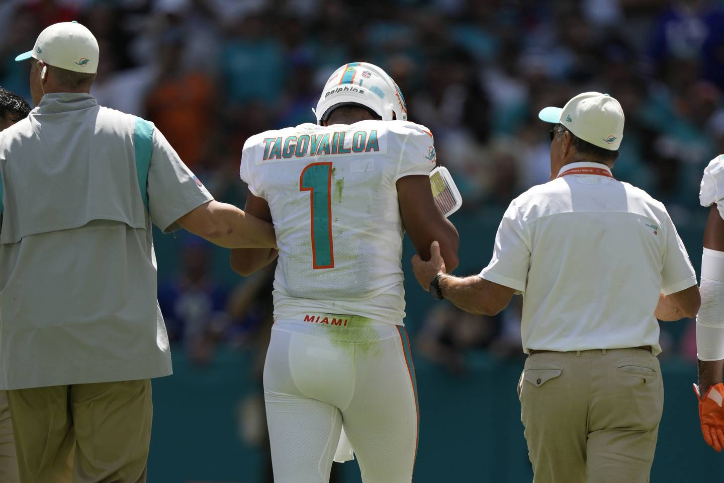Dolphins quarterback Tua Tagovailoa is assisted off the field during the first half of a game against the Bills on Sept. 25 in Miami Gardens, Fla. 