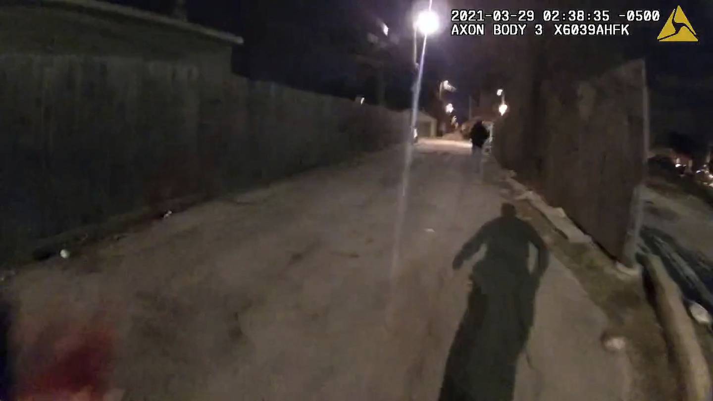 An image from the body camera of Officer Eric Stillman, who has his gun drawn, shows him chasing Adam Toledo in an alley.