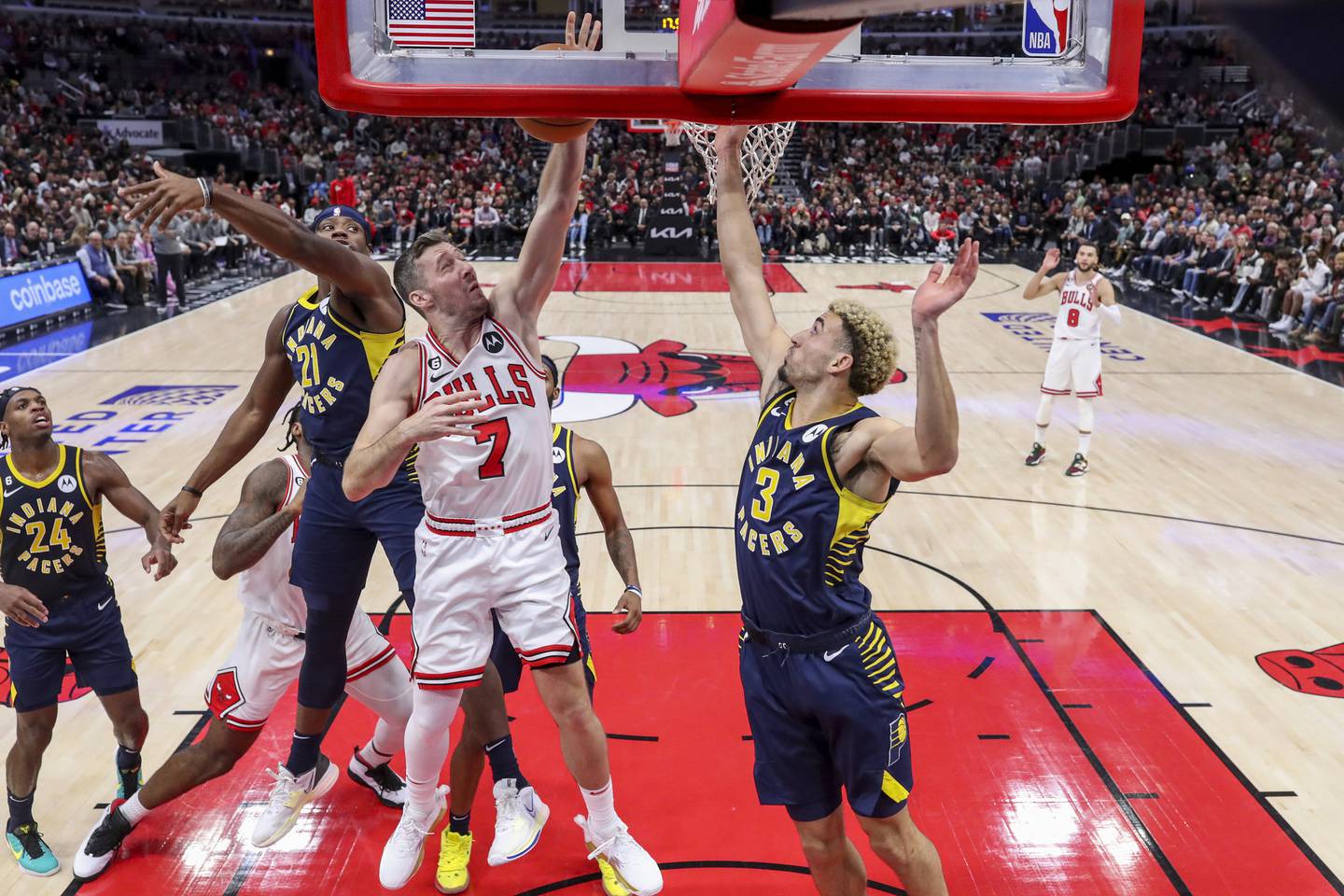 Pacers guard Chris Duarte (3) and forward Terry Taylor (21) defend Bulls guard Goran Dragić as he goes up for a basket during the second half on Oct. 26 at the United Center. 