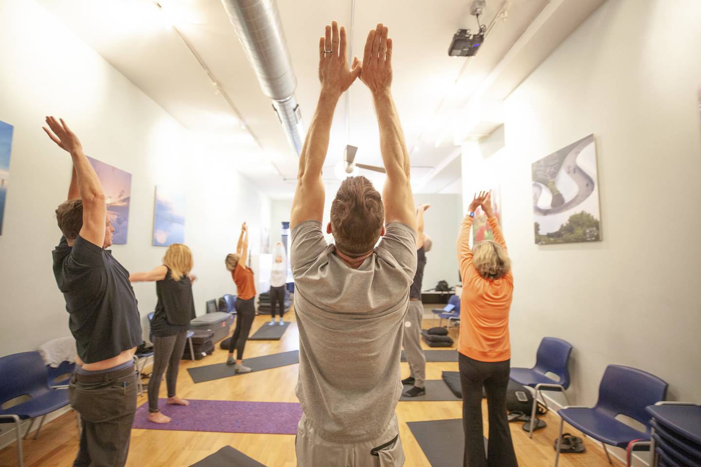 Michael Peterson, center, stretches during a mindfulness and meditation seminar for employees of Dream Town Realty at their training facility in Chicago on Sept. 14, 2022.