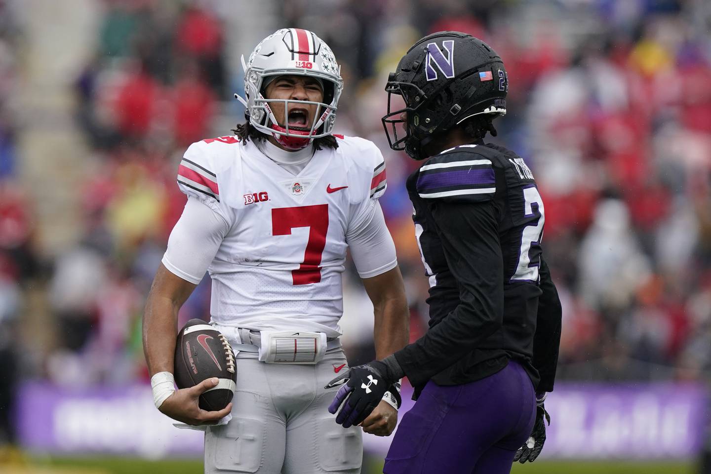 Ohio State quarterback C.J. Stroud, left, reacts in front of Northwestern defensive back Jack Oyola after a long run on Saturday in Evanston, Illinois.