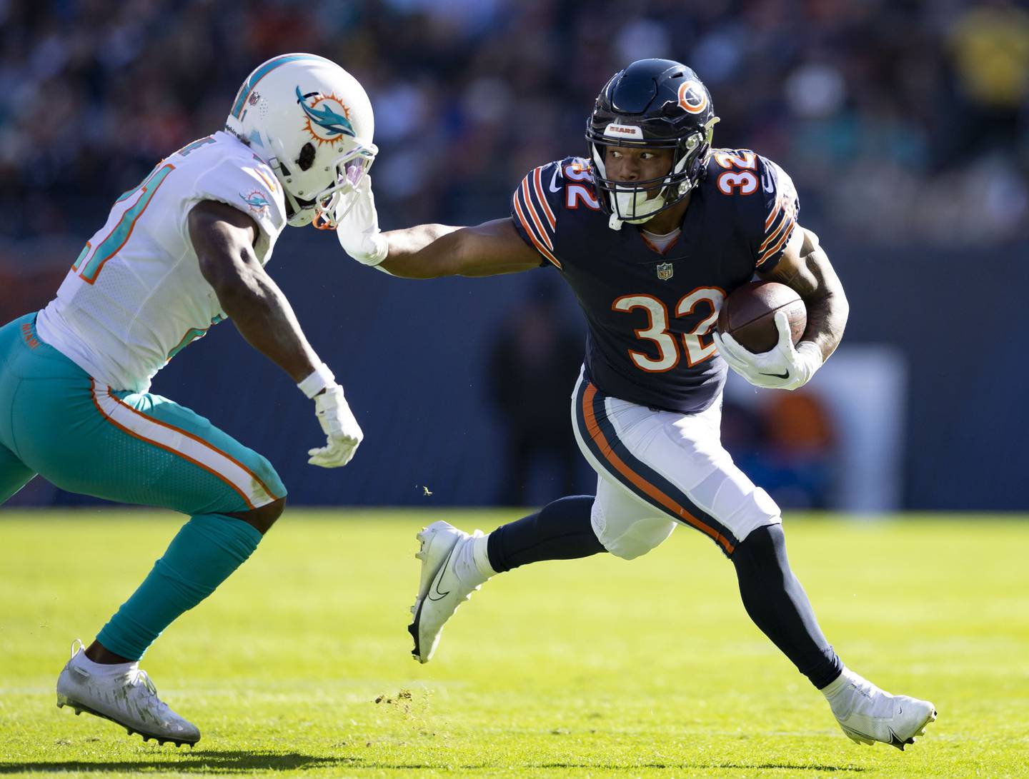 Bears running back David Montgomery (32) stiff-arms Dolphins safety Eric Rowe in the second quarter on Nov. 6 at Soldier Field.