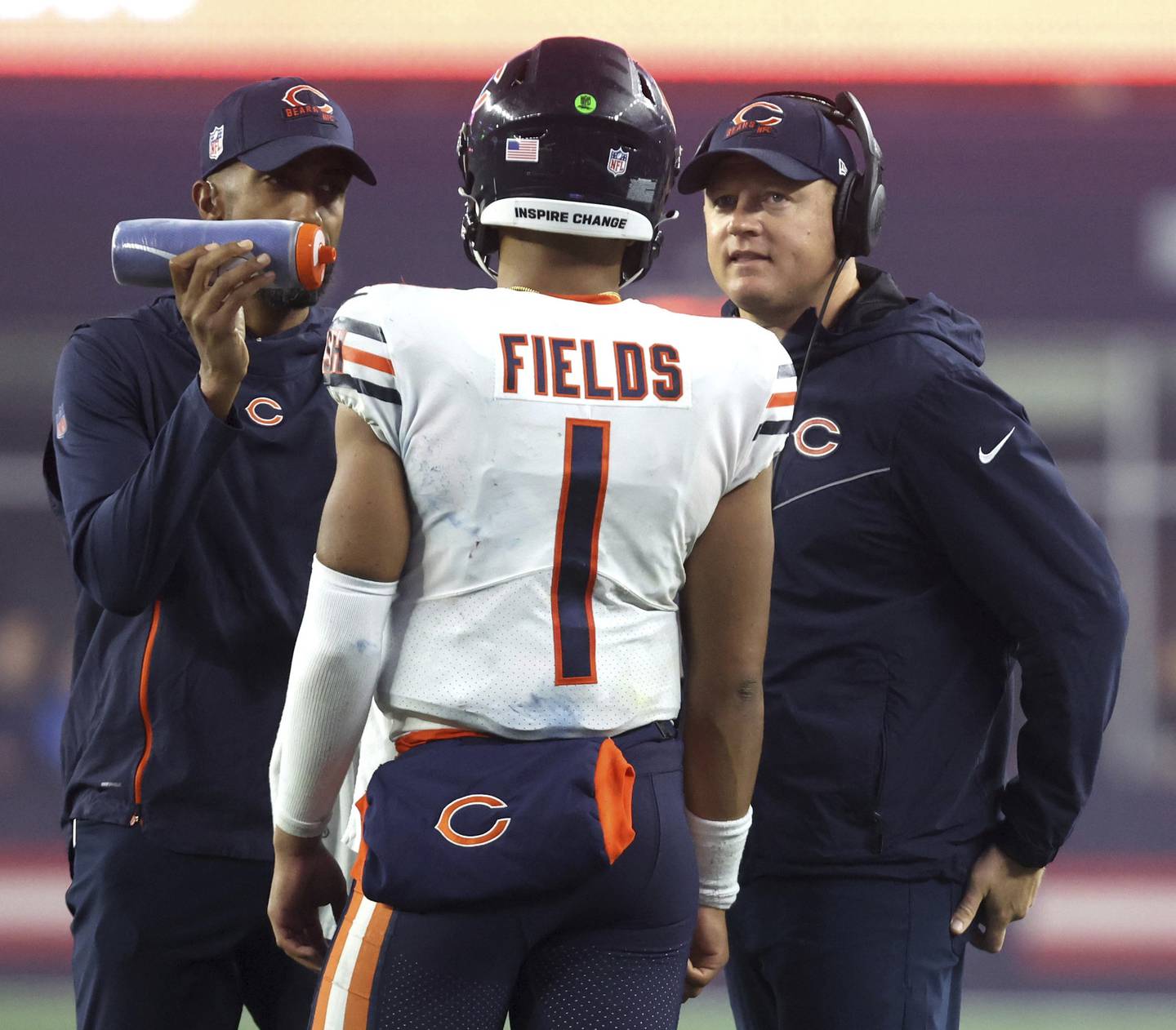 Bears quarterback Justin Fields (1) talls with offensive coordinator Luke Getsy, right, during the fourth quarter against the Patriots on Oct. 24, 2022, at Gillette Stadium in Foxborough, Mass.