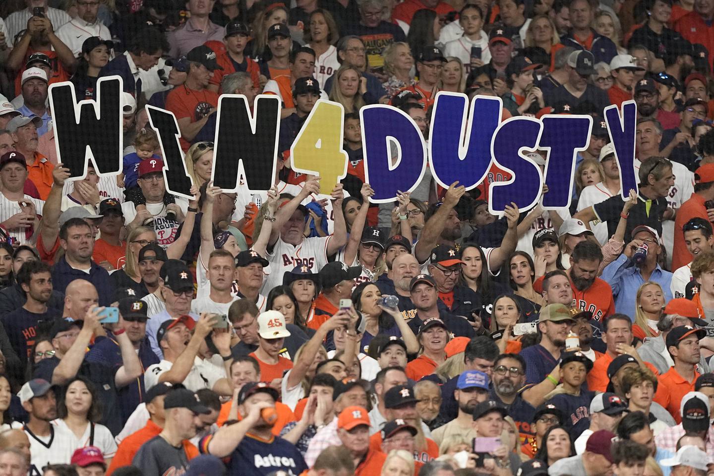 Fans hold up a sign for Astros manager Dusty Baker during the first inning in Game 6 of the World Series on on Nov. 5, 2022.