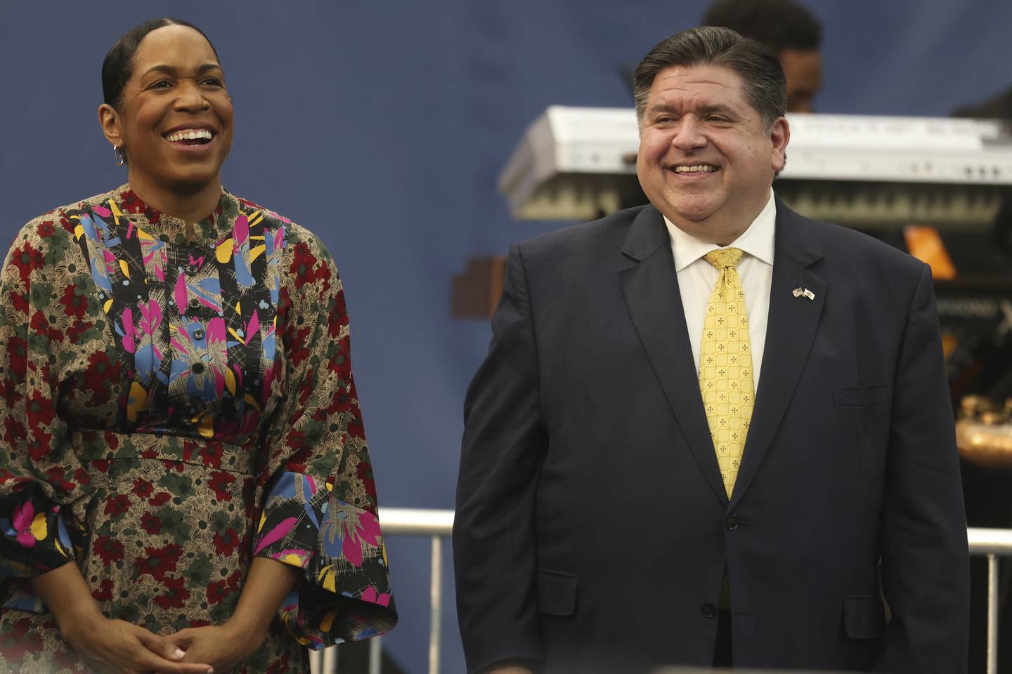 Illinois Gov. J.B. Pritzker and Lt. Gov. Juliana Stratton laugh as Vice President Kamala Harris gives a speech on the upcoming midterm elections at XS Tennis and Education Foundation on Nov. 6, 2022, in Chicago. 