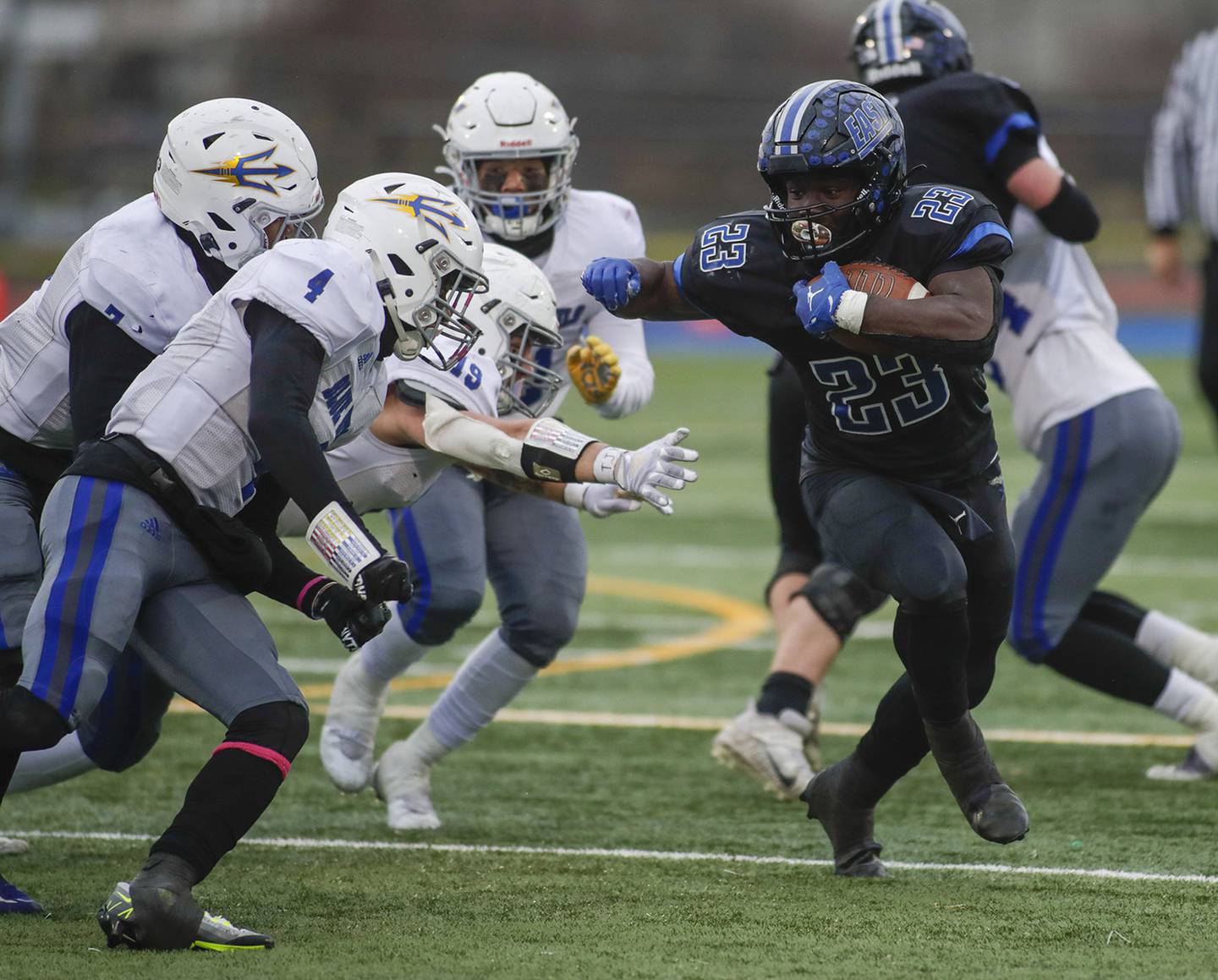 Lincoln-Way East’s Petey Olaleye (23) runs the ball against Warren’s Jaden Turner (4) during a Class 8A state quarterfinal game in Frankfort on Saturday, Nov. 12, 2022.