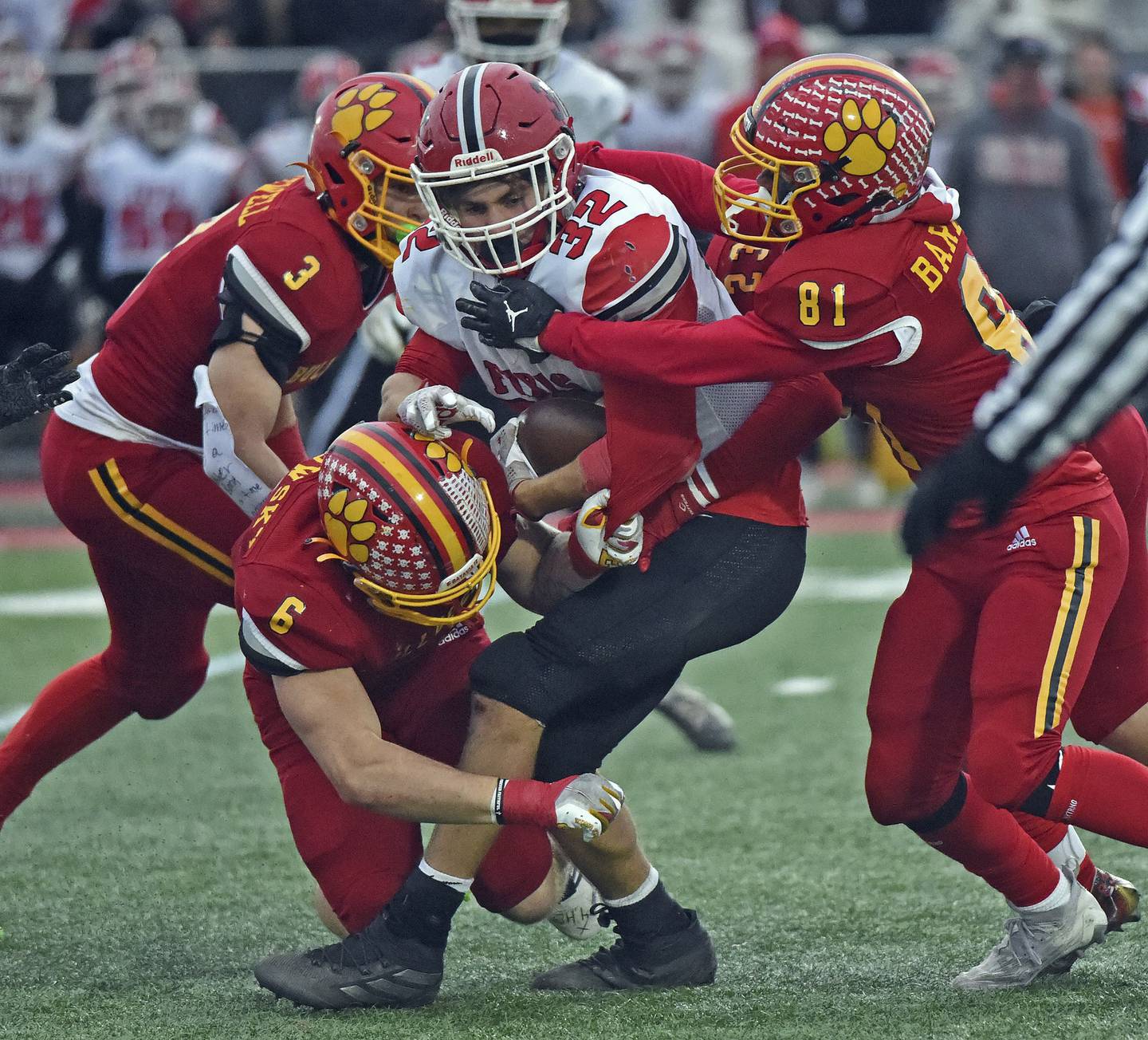 Yorkville's Gio Zeman is brought down by Batavia's Jack Sadowsky and Joey Barbush after a short gain during a Class 7A state quarterfinal game in Batavia on Saturday, Nov. 12, 2022.