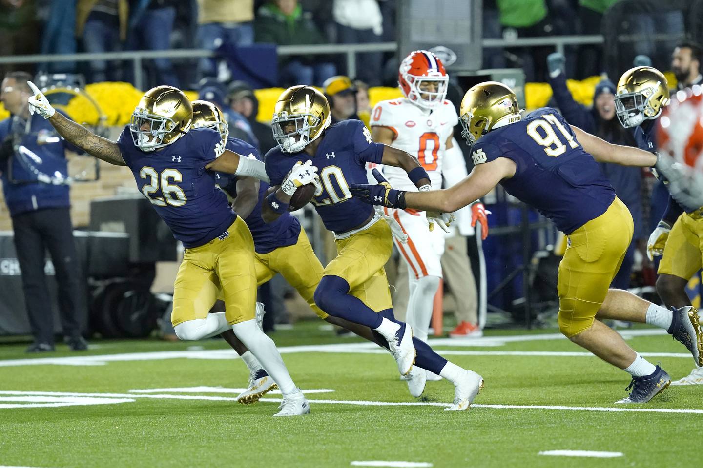 Notre Dame cornerback Benjamin Morrison (20) celebrates with teammates Xavier Watts (26) and Gabriel Rubio after an interception against Clemson on Saturday in South Bend, Ind. Notre Dame won 35-14. 