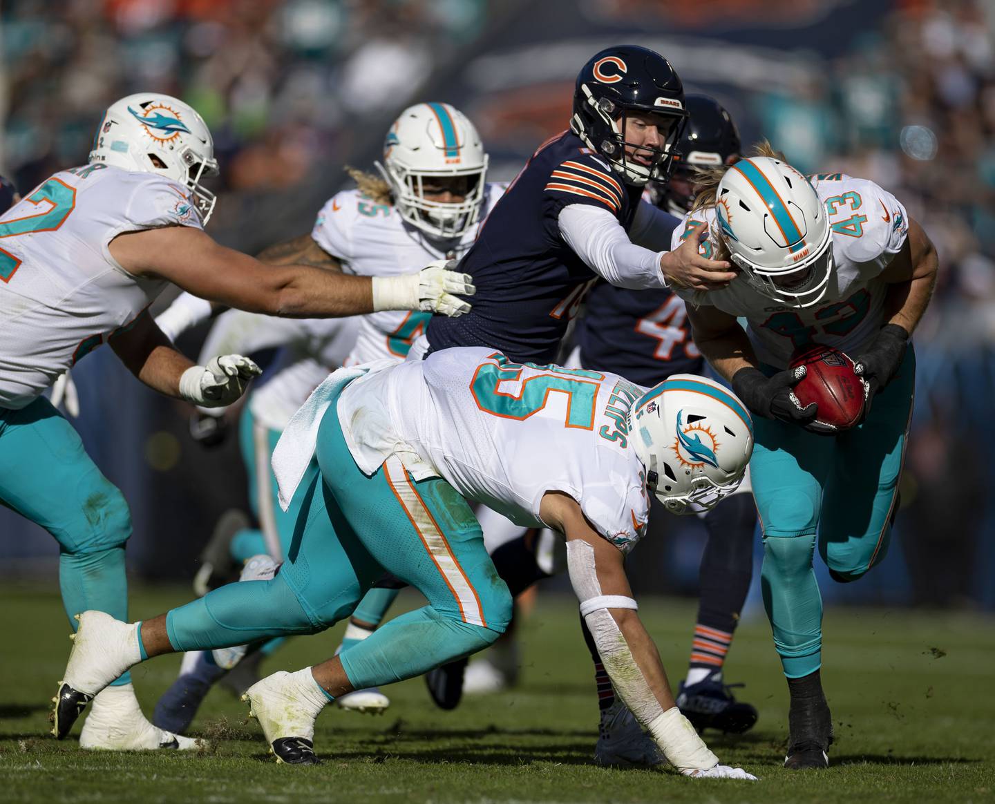 The Dolphins’ Andrew Van Ginkel (43) carries the ball for a touchdown after a blocked punt by Bears punter Trenton Gill (16) in the second quarter Sunday, Nov. 6, 2022, at Soldier Field.