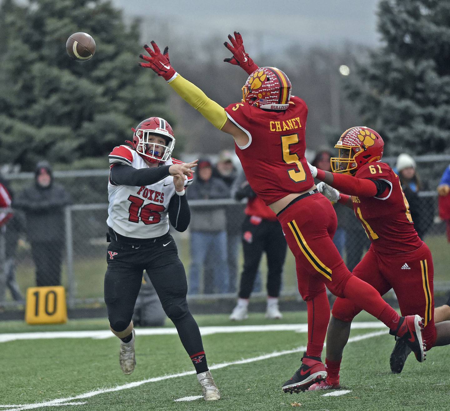 Yorkville quarterback Michael Dopart gets pressured by Batavia's JP Chaney and Jordan Buckley during a Class 7A state quarterfinal game in Batavia on Saturday, Nov. 12, 2022.