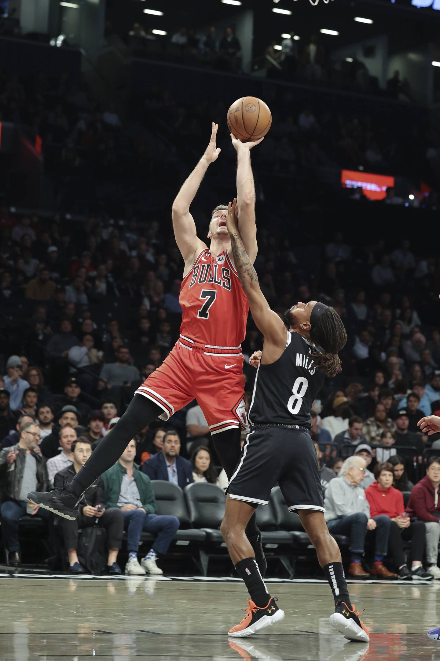 Bulls guard Goran Dragić (7) is fouled by Nets guard Patty Mills (8) during the first half Tuesday, Nov. 1, 2022, in New York.
