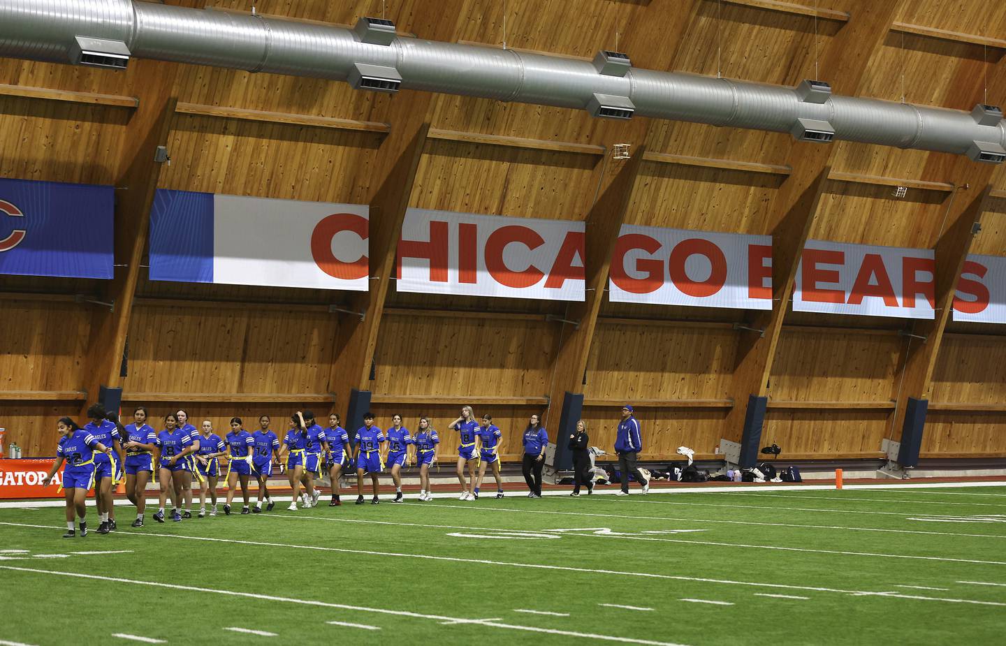 Taft High School players come out onto the field before the start of the semifinal games at the first-ever “Chicago Bears Girls Flag State Championship” at Halas Hall in Lake Forest on Oct. 29, 2022. 