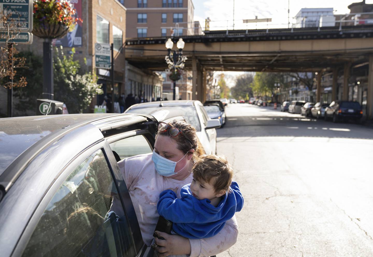 Zaharia Baker, with her son Joseph, picks up food for her family at Nourishing Hope on Nov. 11 2022.